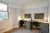 an office with a desk and chair in a room