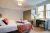 a bedroom with a bed and desk in a room