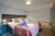 a bedroom with a bed and desk in a room