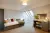 a bedroom with a bed and desk in a room
