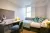 a bedroom with a bed and desk in a room