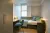 a bedroom with a bed and desk in a room
