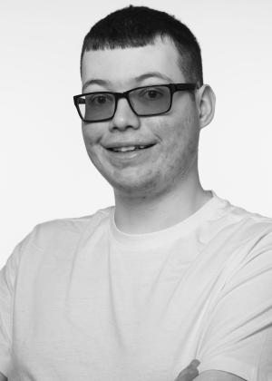 a man wearing glasses posing for the camera