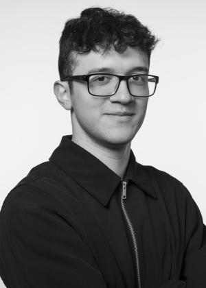 a man wearing glasses and looking at the camera