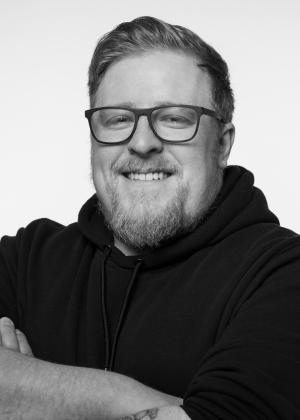 a man wearing glasses and looking at the camera