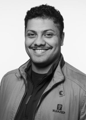 a man wearing glasses posing for the camera