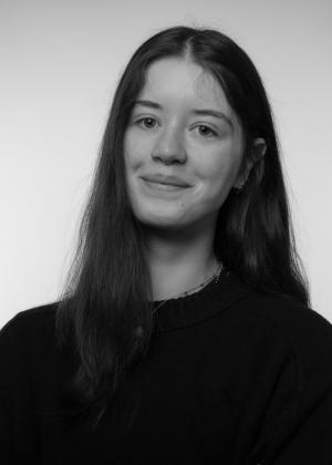 a person who is smiling and looking at the camera