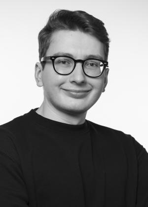 a man wearing glasses posing for the camera