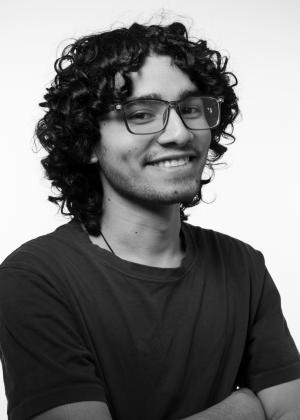 a man wearing glasses and looking at the camera