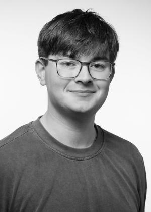 a man wearing glasses posing for the camera