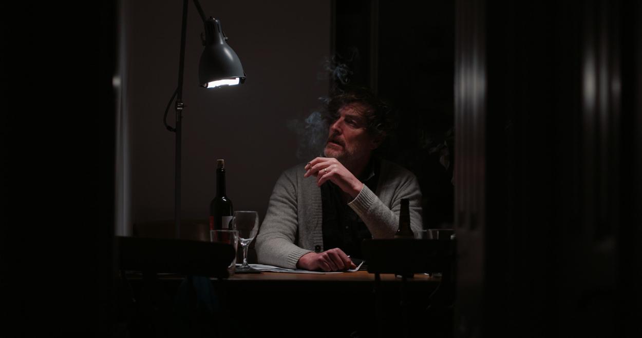 A still of Anthony Murphy smoking.  