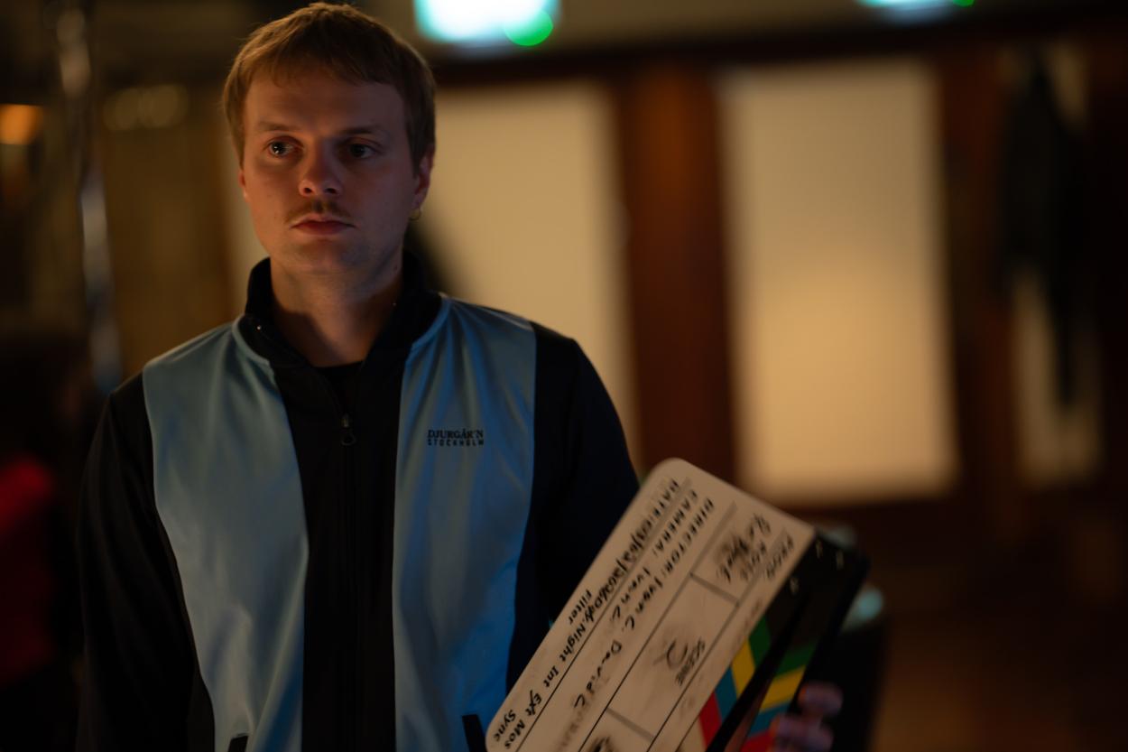 Alex standing with the clapboard.  
