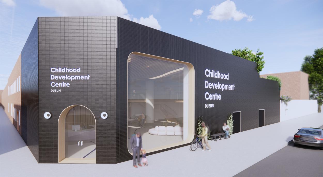 This image shows the exterior of the building from the street. It shows the black brick cladding and the big window in the reception area, as well as the signage. 