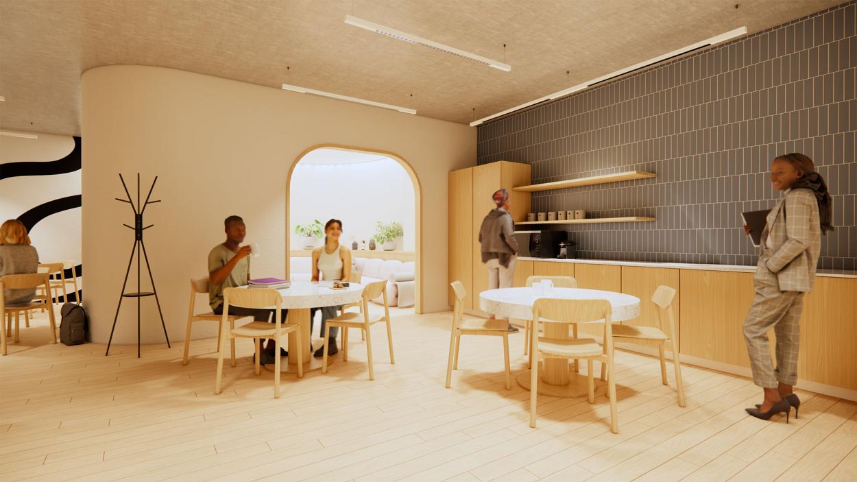 This image shows the staff area, specifically the kitchenette and the seating areas, with people milling about. 