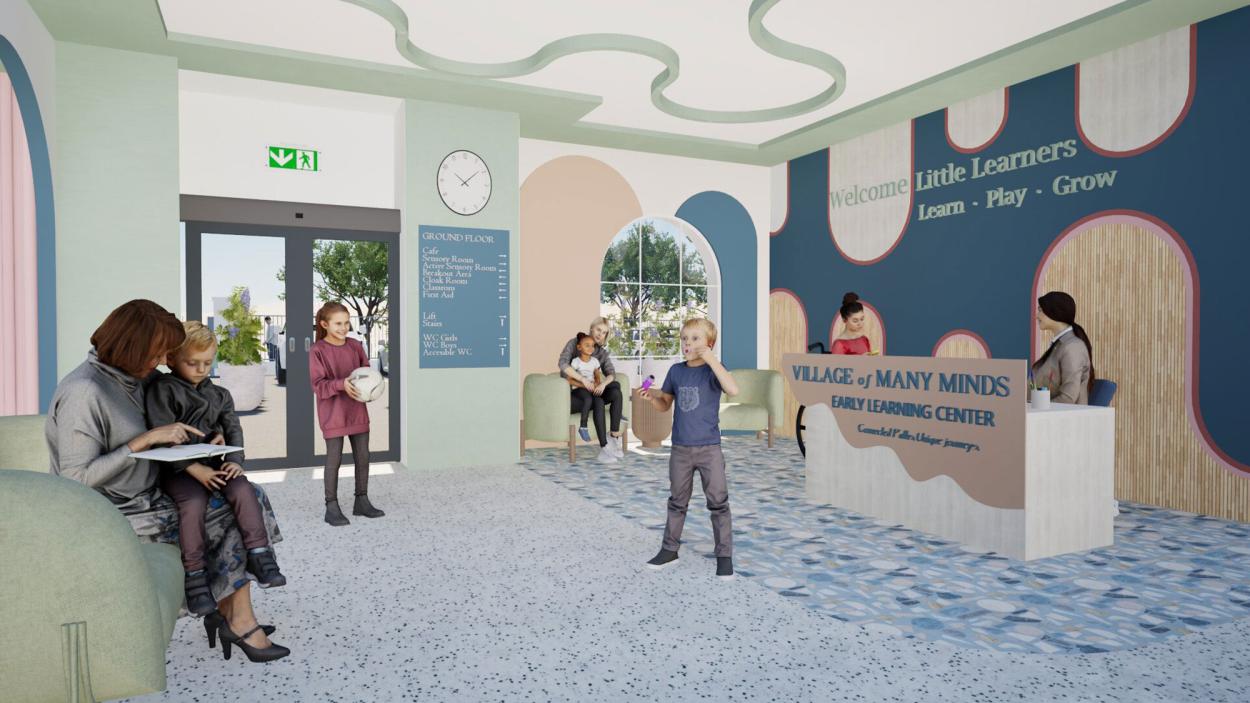 A welcoming reception area within the early learning center featuring playful pastel tones, curved ceiling details, terrazzo flooring, branded signage, arched forms, and comfortable seating areas designed to create an engaging and child-friendly arrival experience for families.