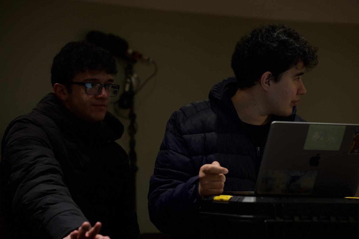 a man sitting in front of a laptop computer
