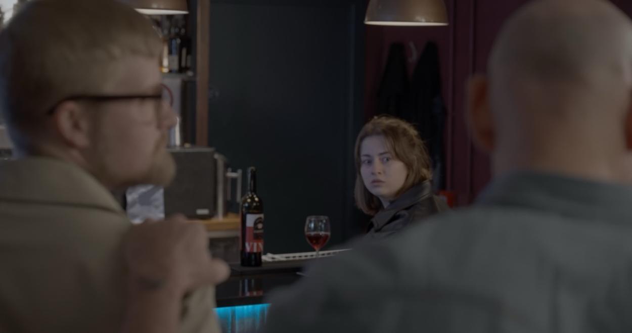 a man and a woman looking at the camera