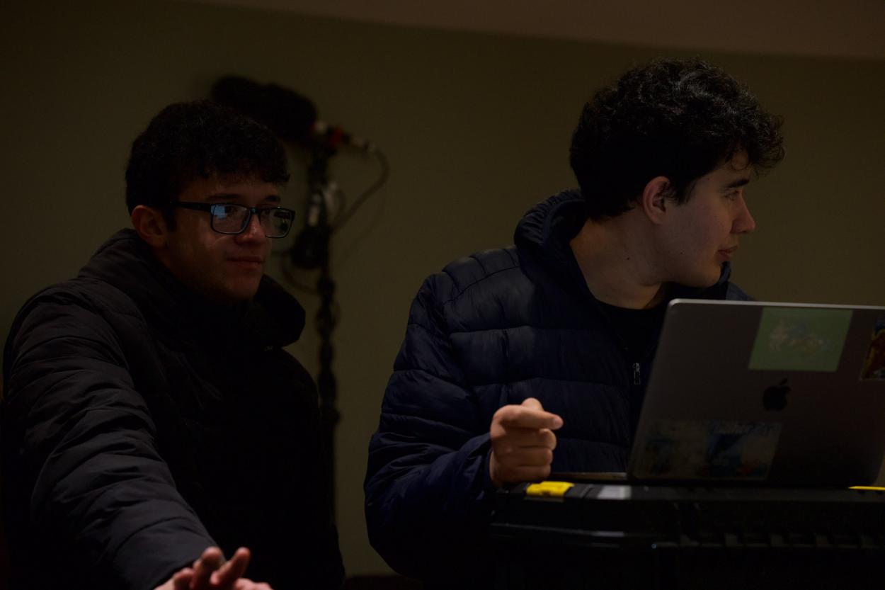 a man sitting in front of a laptop computer