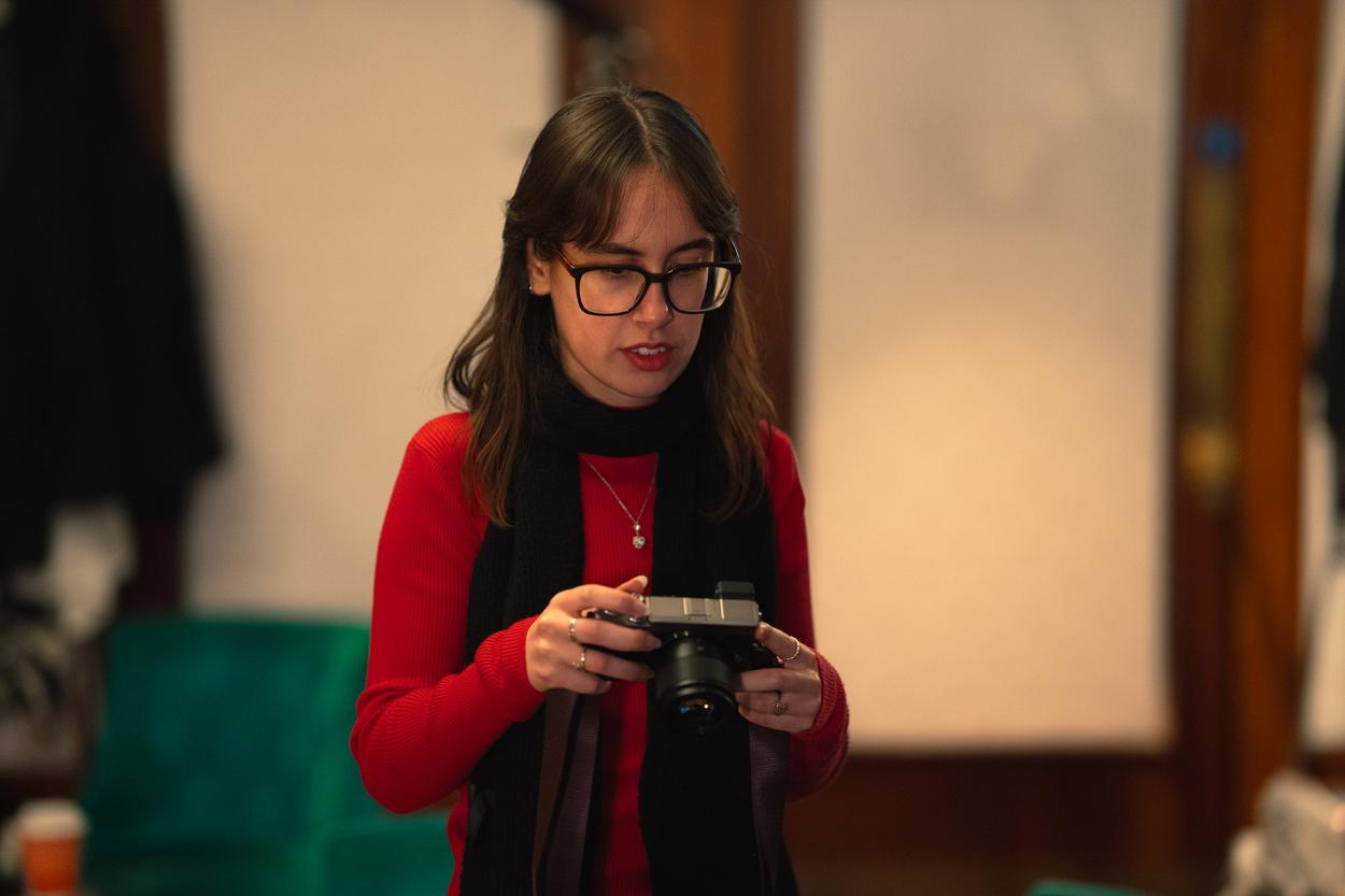 Diana Favaro taking pictures on set of “Only Way Out Is Through” (“Gentle Threats” chapter 2). 