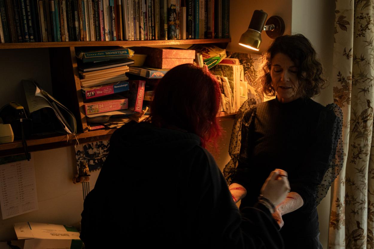 a man and a woman standing in front of a mirror