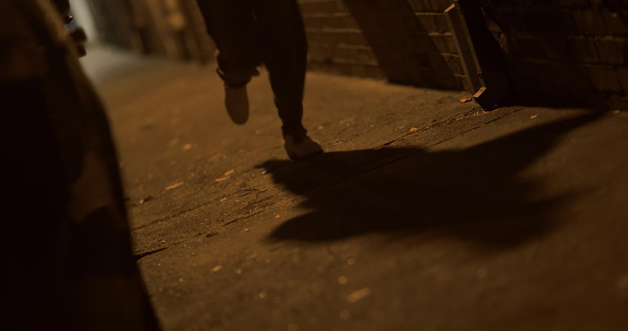 Film still from Gentle Threats, Saoirse running to the bar during the collision scene (between chapters 1 and 2). 