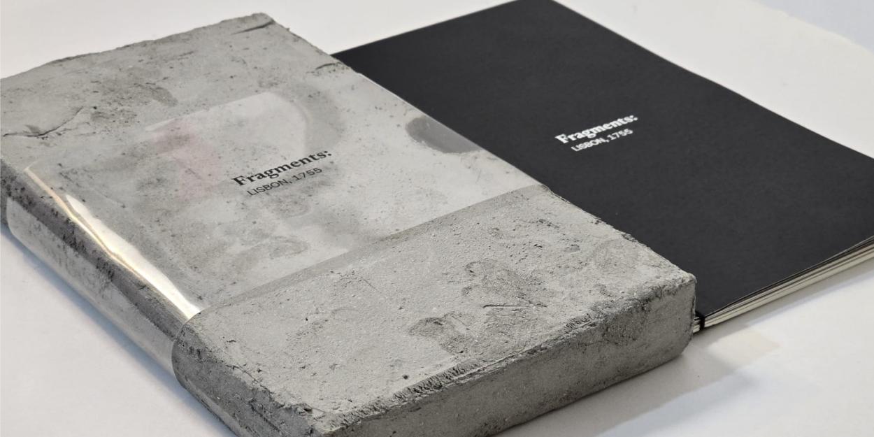 A black book titled "Fragments: Lisbon, 1755" next to its textured, concrete-like case with a translucent sleeve