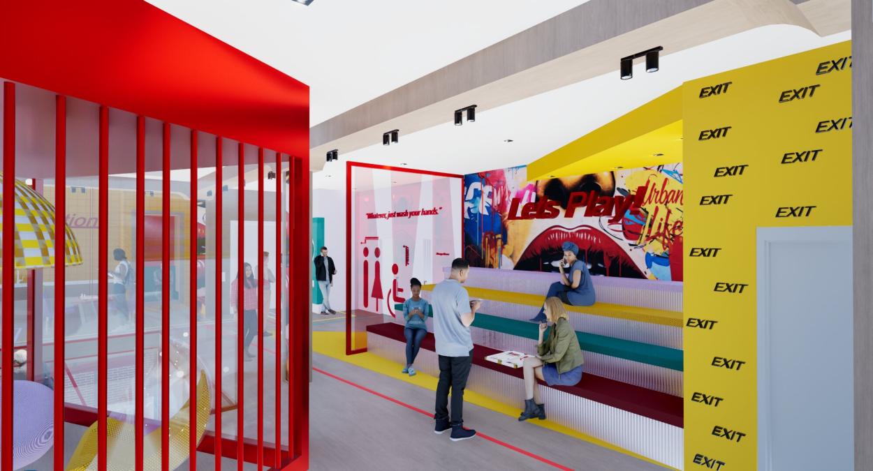 Game room floor with stepped seating, bright yellow feature wall, and informal social  areas, designed for relaxation, entertainment, and community engagement.
