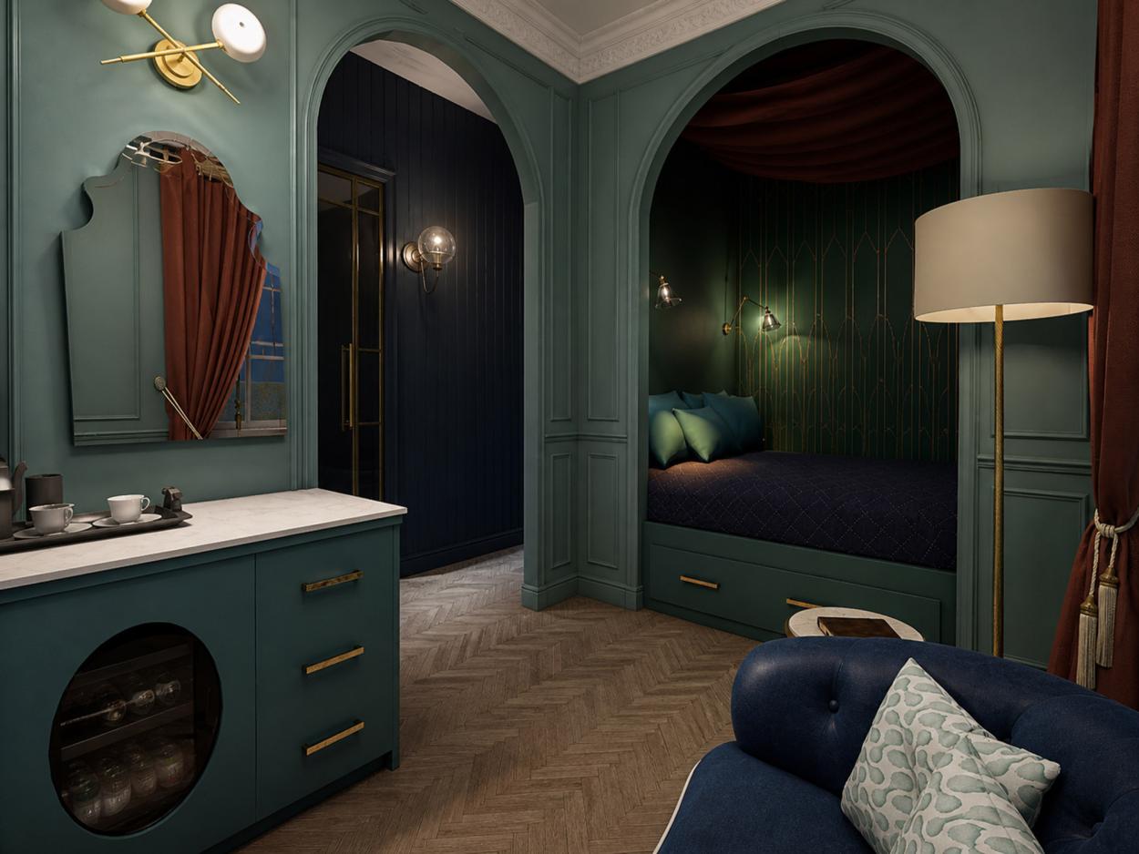 Image shows a guest bedroom render with teal panelled walls, arched bed alcove, dark green wallpaper, brass lighting, marble-topped mini bar, blue sofa, red curtains and warm timber flooring. 