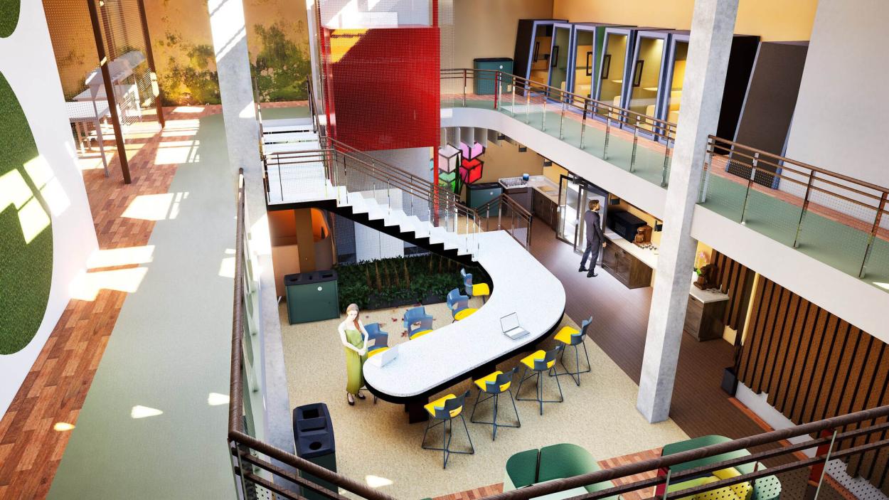 The image shows a top view of the common area, especially the staircase which is a table but also functions as an event runaway; this area is very social and is where serendipity happens. 