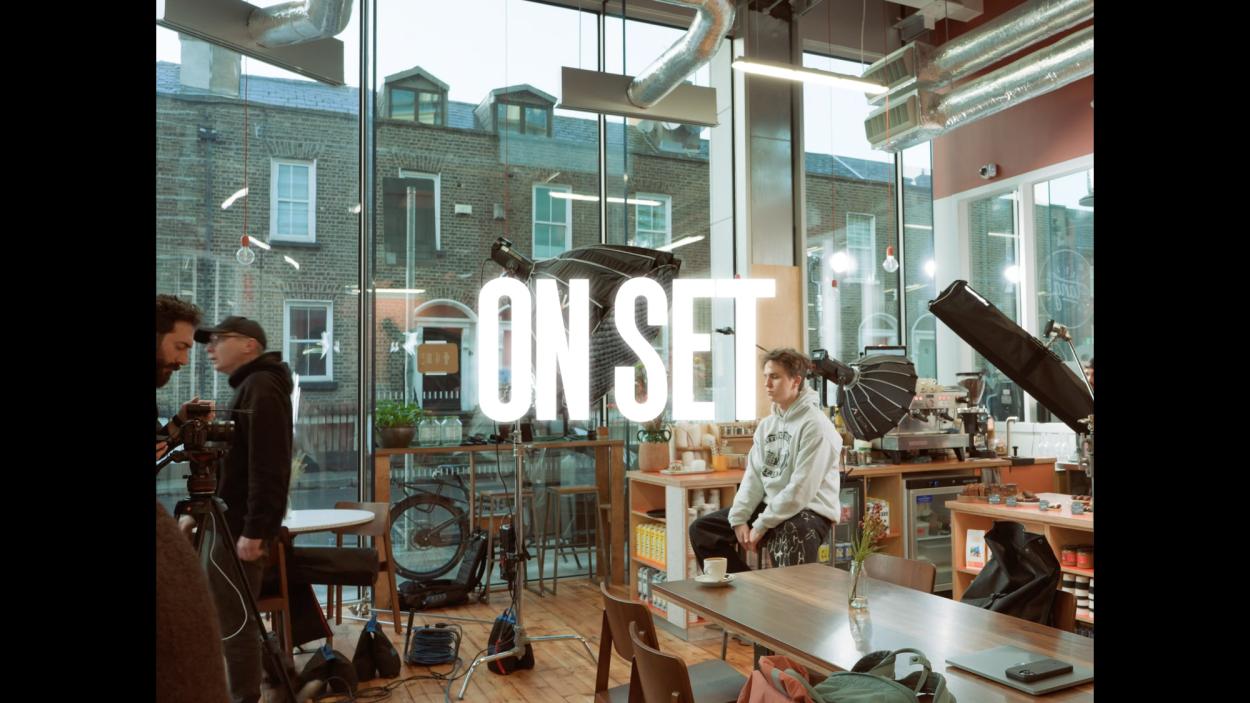 a group of people sitting at a table in front of a building
