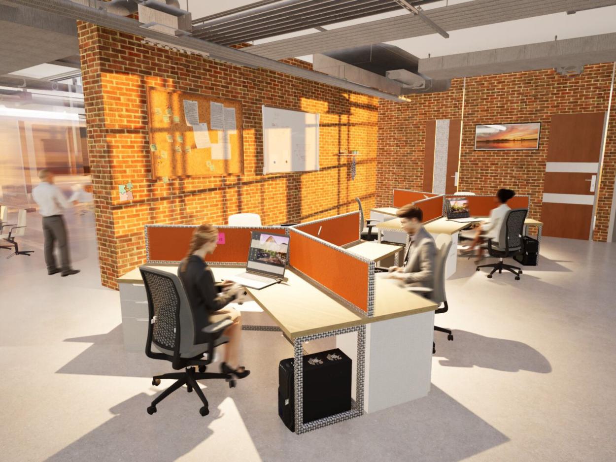 a group of people sitting at a desk in a room