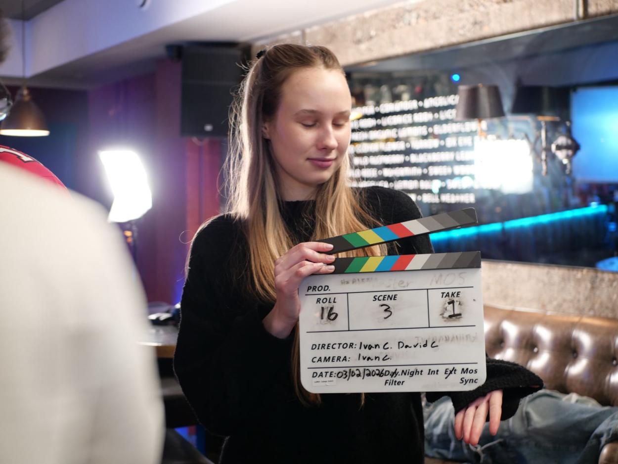Holding a clap board