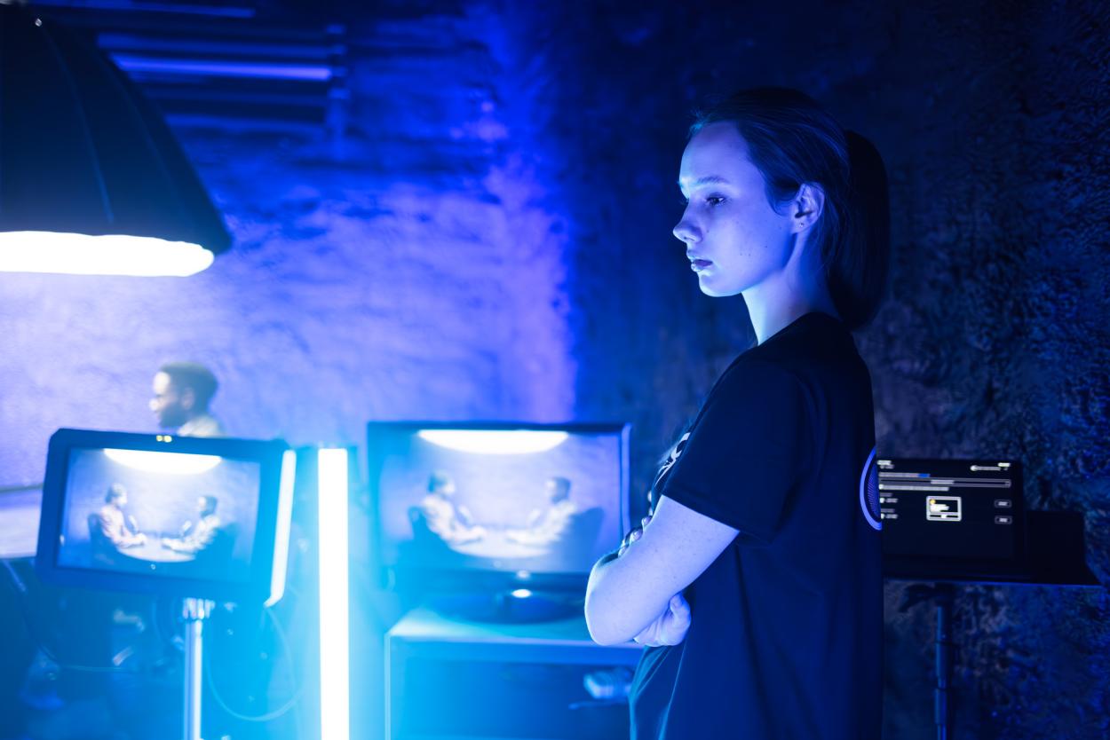 Monitoring the scene during filming on set. 