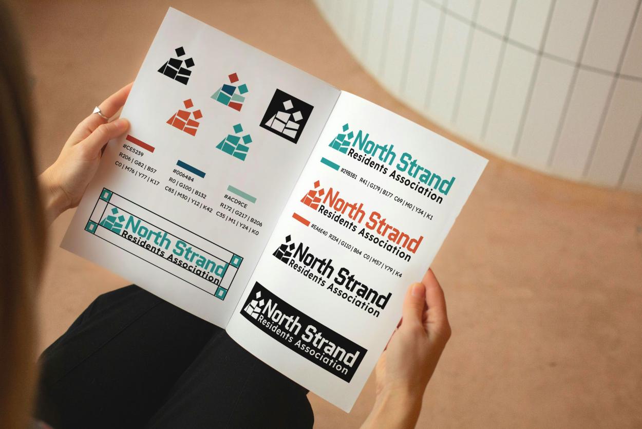 An open style guide booklet showing different logo variations.