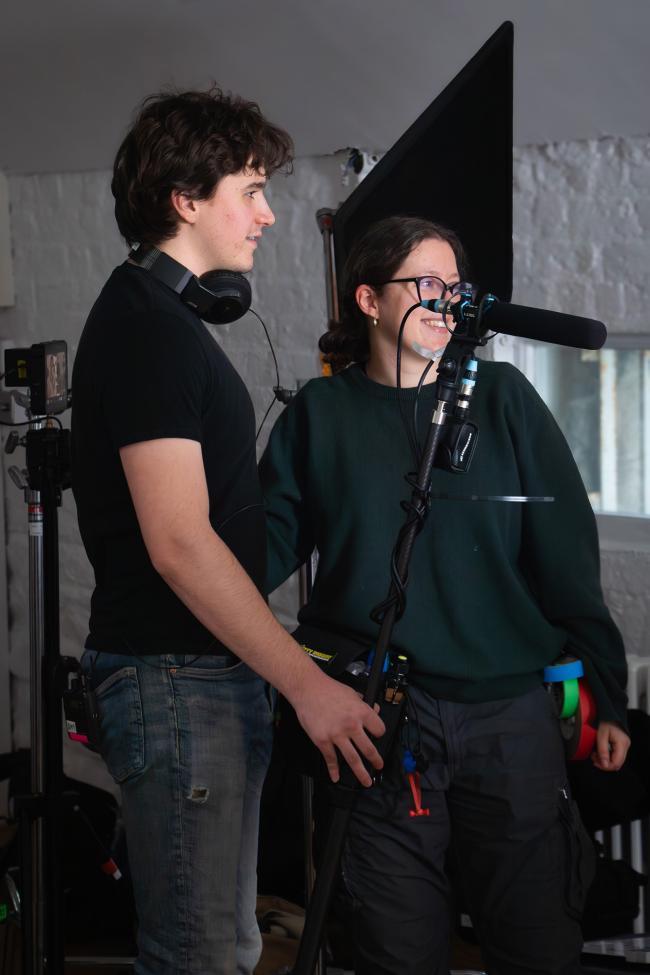 a man standing next to a woman