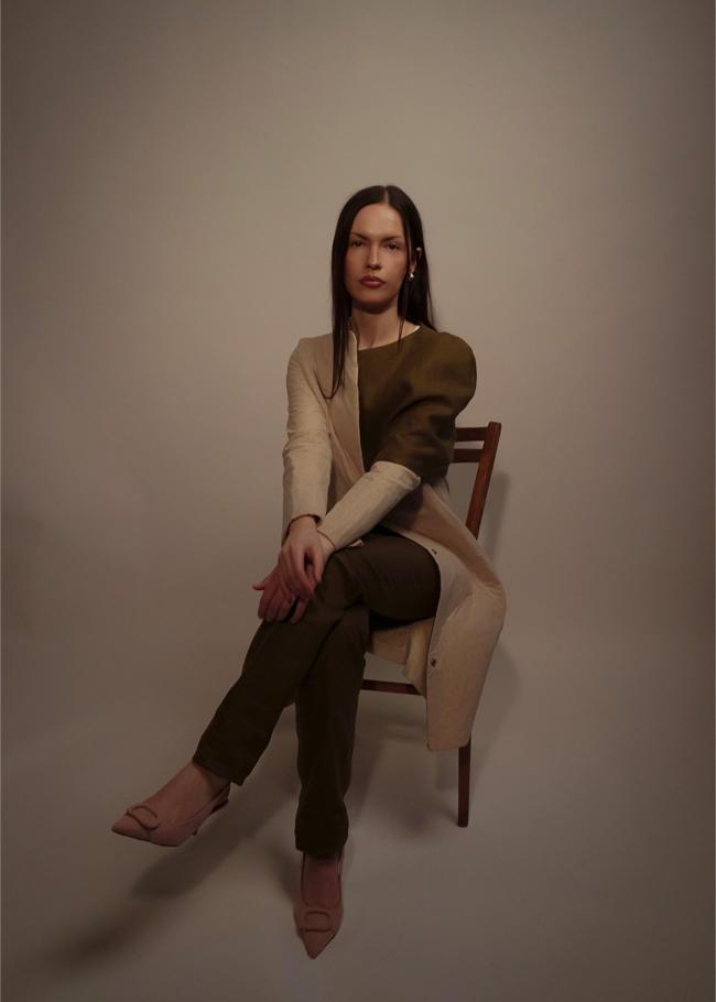 Model wearing coat with shawl detail