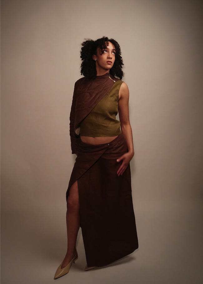 Model wearing matching quilted shawl and wrap skirt, standing