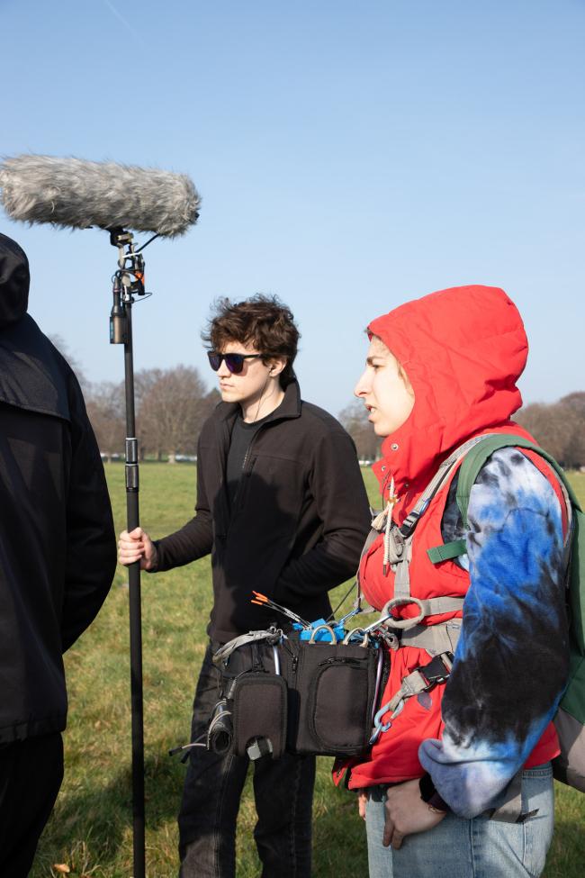 a group of people standing in the grass
