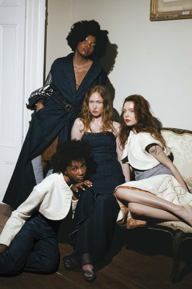 Four models posed together on an antique couch, wearing garments made form denim and Irish báinín wool.