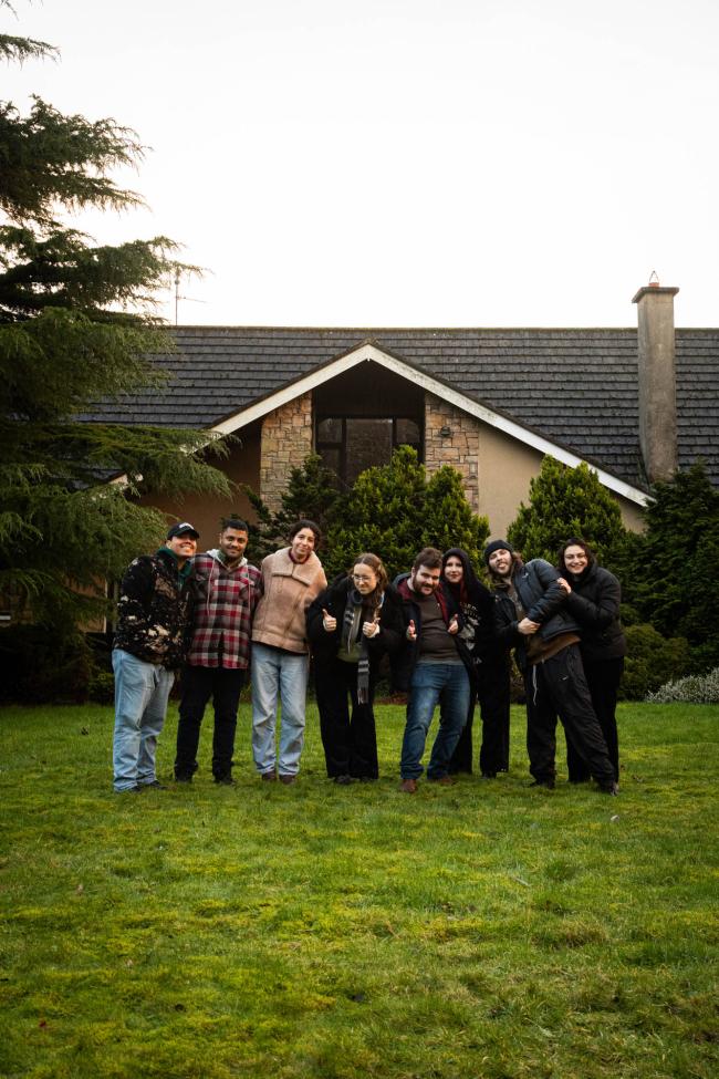 a group of people standing in front of a house