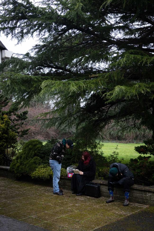 a group of people standing next to a tree
