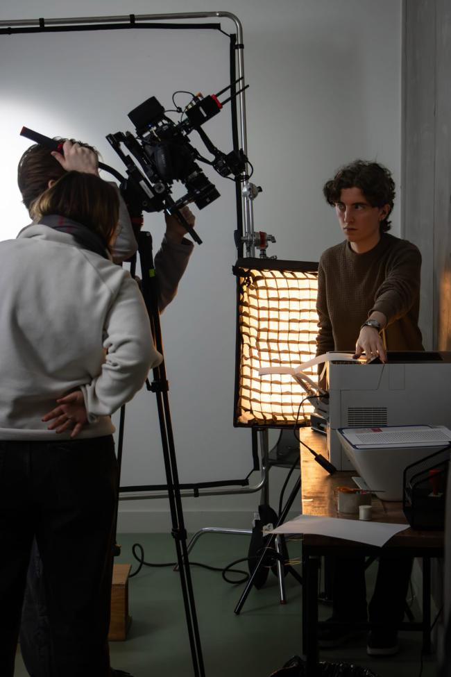 a man standing in front of a laptop