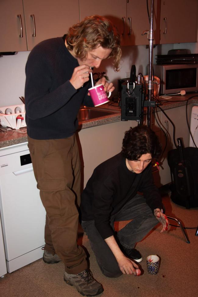 a man and a woman standing in a kitchen