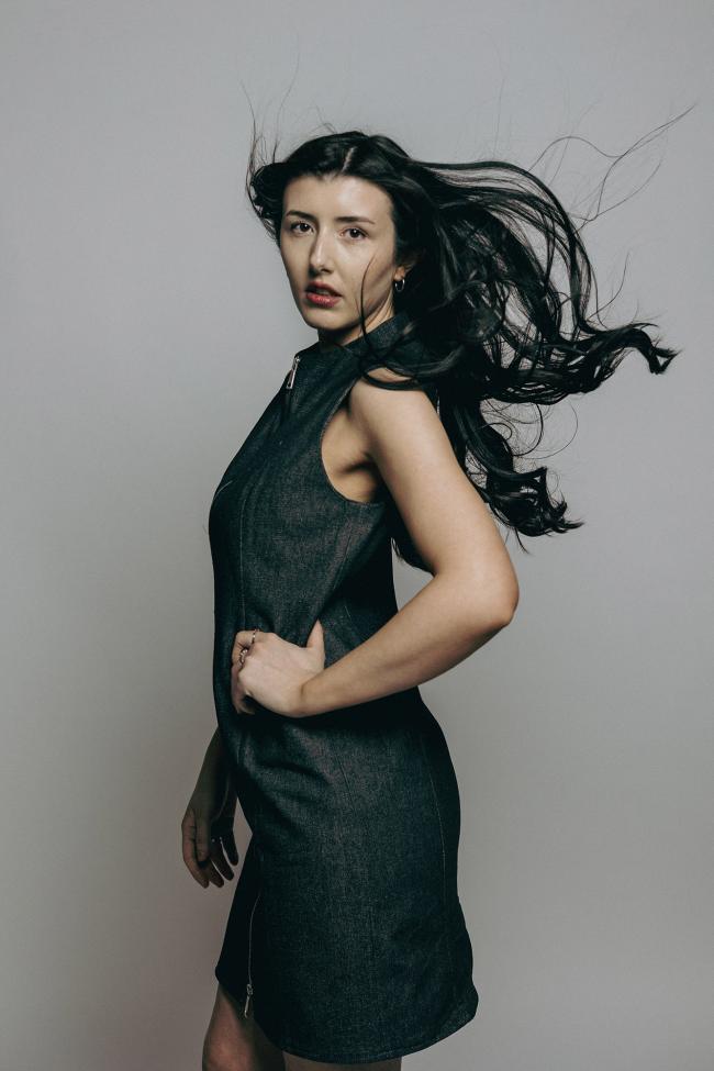 A model posing to the side to show off arm detail.