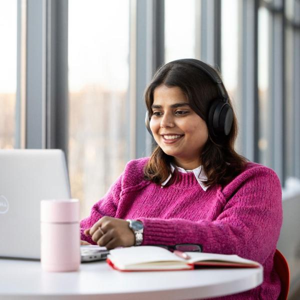 a woman sitting at a table in front of a window