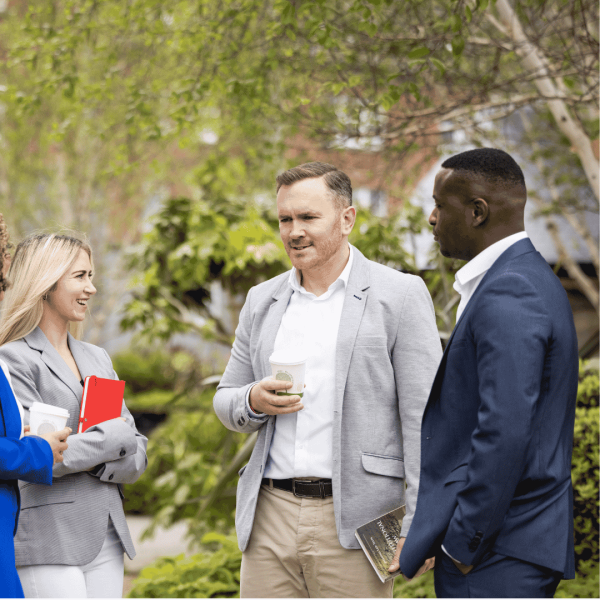 a group of people standing in the grass