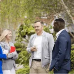 a group of people standing in the grass