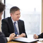 a group of people sitting at a desk