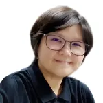 a boy wearing glasses and smiling at the camera